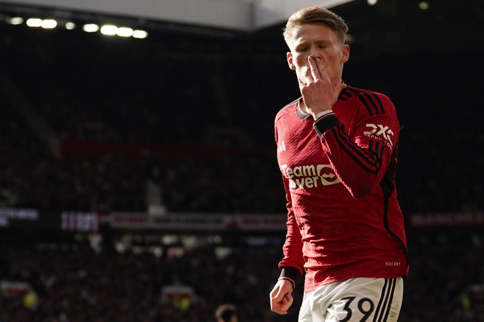 Manchester United's Scott McTominay celebrates after scoring his side's opening goal during the FA Cup quarterfinal soccer match between Manchester United and Liverpool at the Old Trafford stadium in Manchester, England, Sunday, March 17, 2024. (AP Photo/Dave Thompson)