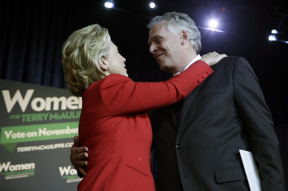 Former U.S. Secretary of State Hillary Clinton greets former DNC chairman Terry McAuliffe at an event to endorse him as Virginia gubernatorial candidate at The State Theatre in Falls Church, Virginia, October 19, 2013. REUTERS/Yuri Gripas (UNITED STATES - Tags: POLITICS ELECTIONS)