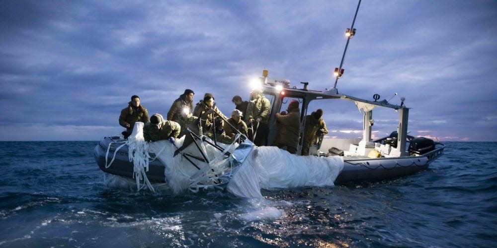 Sailors assigned to Explosive Ordnance Disposal Group 2 recover a high-altitude surveillance balloon off the coast of Myrtle Beach, South Carolina, Feb. 5, 2023.