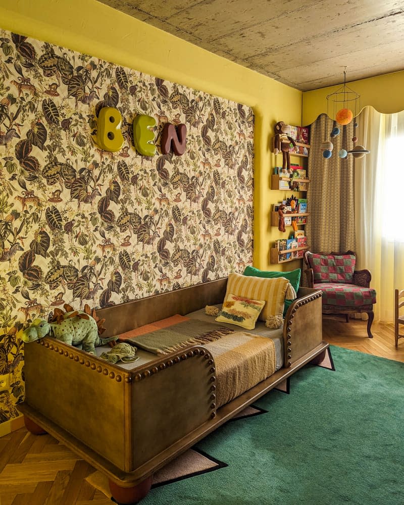 Yellow kids room with botanical wallpaper accent wall and brown leather and wood bed