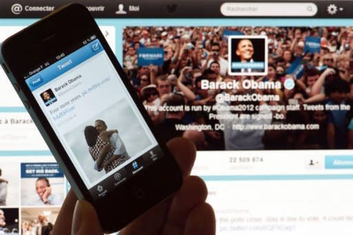 A person poses with a cell phone in front of a computer screen to check Barack Obama's tweet after his re-election as US president. Obama sealed his tech-savvy reputation late Tuesday by announcing his victory over Republican foe Mitt Romney on Twitter and Facebook with the photo