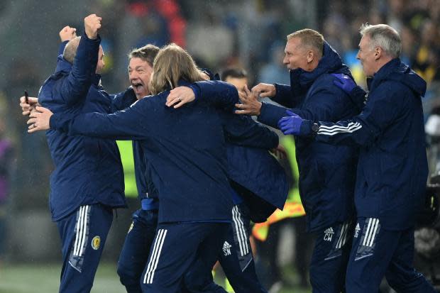 Scotland manager Steve Clarke, left, celebrates with his backroom team after the 0-0 draw with Ukraine in Poland