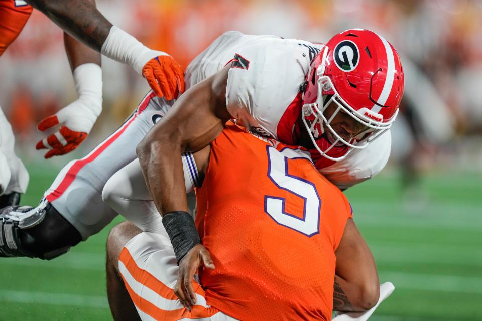 Sep 4, 2021; Charlotte, North Carolina, USA; Clemson Tigers quarterback D.J. Uiagalelei (5) is sacked by Georgia Bulldogs linebacker Quay Walker (7) during the first quarter at Bank of America Stadium. Mandatory Credit: Jim Dedmon-USA TODAY Sports