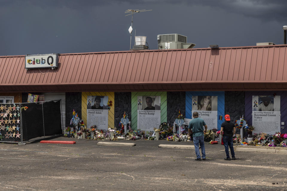 People visit a memorial outside Club Q, the LGBTQ nightclub that was the site of a deadly 2022 shooting that killed five people, on Wednesday, June 7, 2023 in Colorado Springs, Colo. Anderson Lee Aldrich faces more than 300 state counts, including murder and hate crimes. And the U.S. Justice Department is considering filing federal hate crime charges, according to a senior law enforcement official familiar with the matter who spoke to AP in 2023 on condition of anonymity to discuss the ongoing case. (AP Photo/Chet Strange)