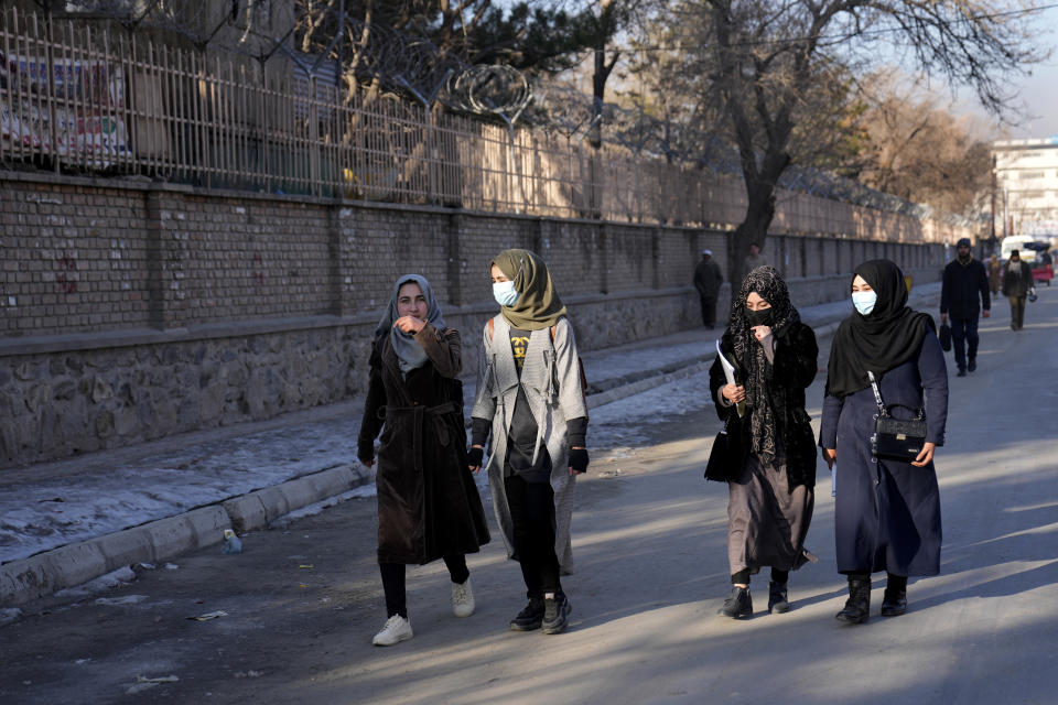 Afghan students walk toward their university in Kabul, Afghanistan, Saturday, Feb. 26, 2022. Kabul University, among Afghanistan’s oldest and most revered institutions of higher education, reopened Saturday six months after the Taliban retook the country. There were new restrictions in place, however, including gender segregation and mandatory Islamic dress. (AP Photo/Hussein Malla)