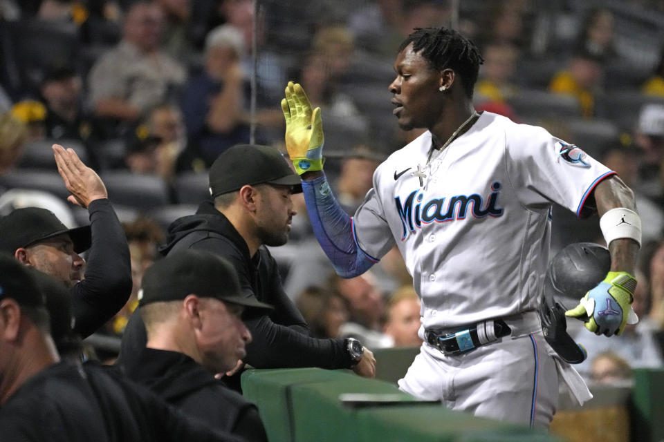 Miami Marlins' Jazz Chisholm Jr., right, returns to the dugout after hitting a solo home run off Pittsburgh Pirates starting pitcher Quinn Priester during the third inning of a baseball game in Pittsburgh, Saturday, Sept. 30, 2023. (AP Photo/Gene J. Puskar)