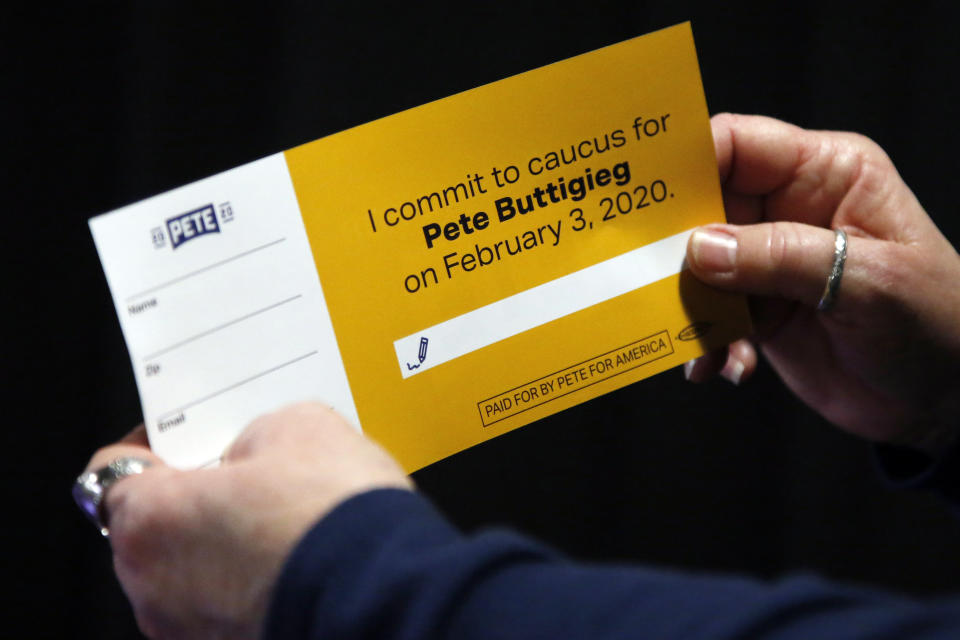 A woman holds a caucus card for Democratic presidential candidate former South Bend, Ind., Mayor Pete Buttigieg at a town hall meeting Tuesday, Jan. 28, 2020, in Indianola, Iowa (AP Photo/Sue Ogrocki)