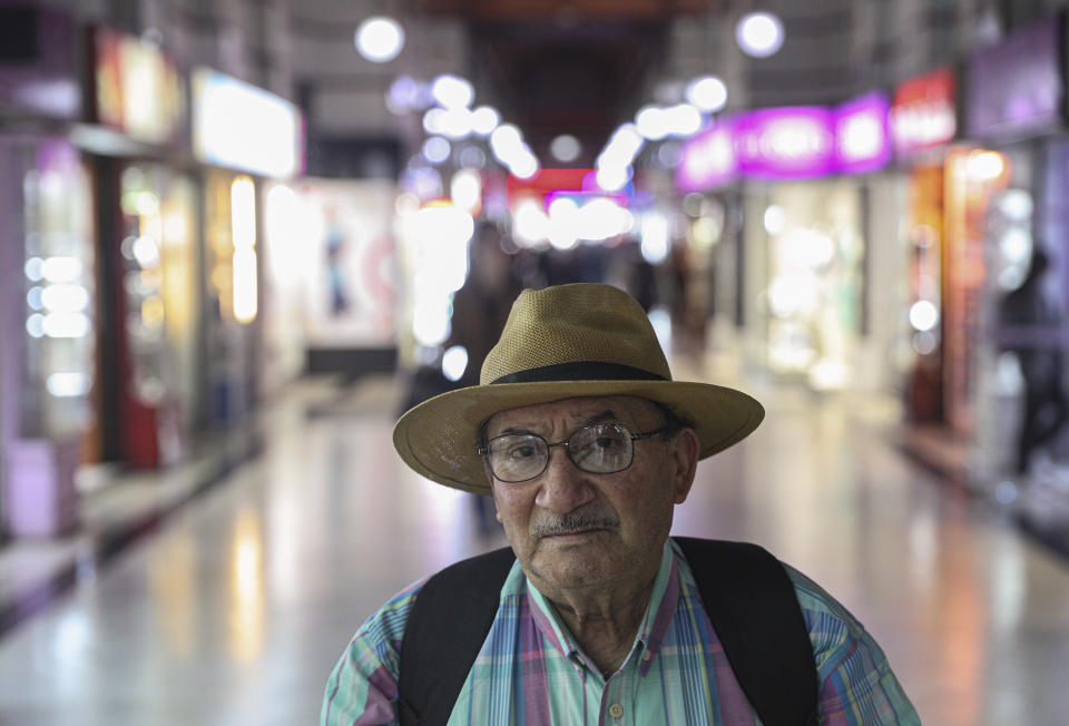 In this Nov. 5, 2019 photo, retired Nestor Osorio, 66, poses for a photo after a day of work in downtown Santiago, Chile. What started on Oct. 18 as a student protest over a modest subway fare hike has ballooned into a massive, mostly peaceful social uprising that continues to consume Chile. The protests include struggling retirees. (AP Photo/Esteban Felix)