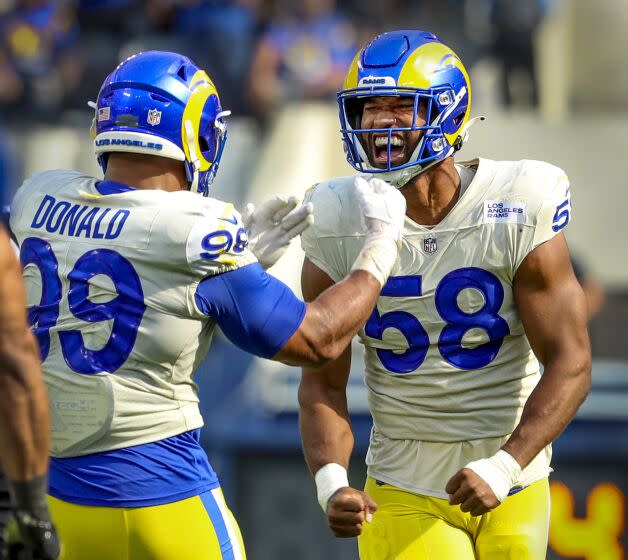 Los Angeles, CA - September 18: Rams defensive lineman Aaron Donald, left, celebrates.