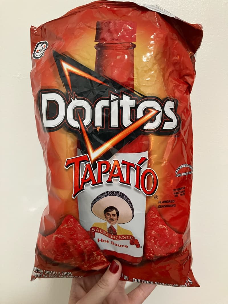 Someone holding bag of Tapatío Doritos