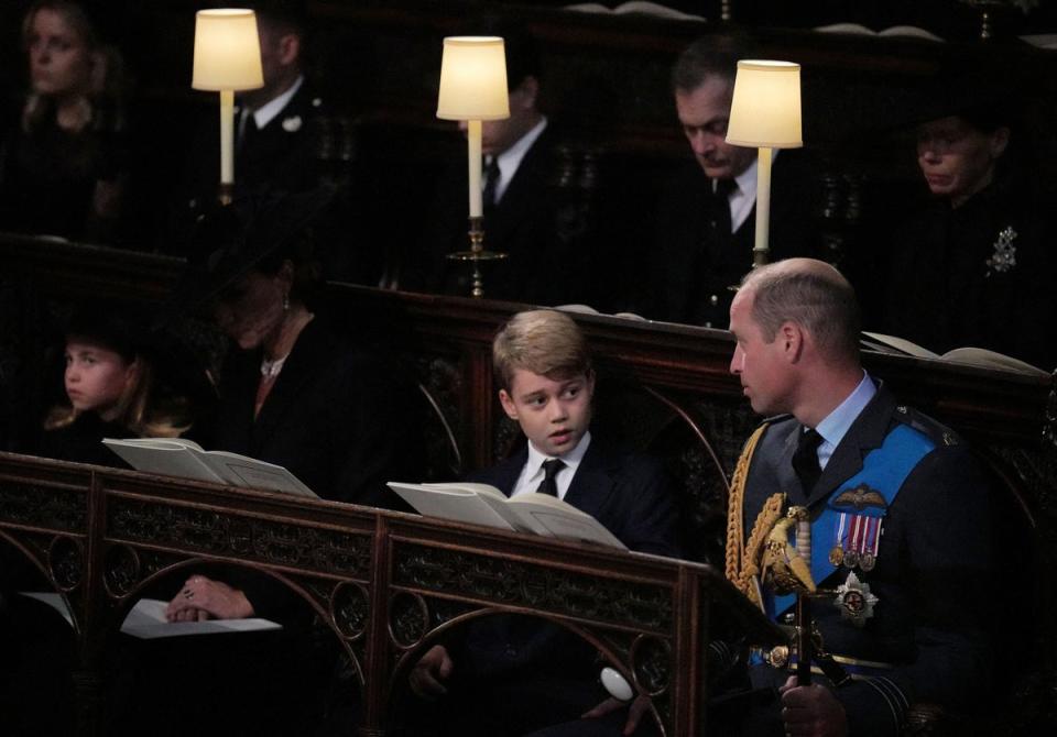 Prince George (centre) speaks with his father, William, Prince of Wales (POOL/AFP via Getty Images)