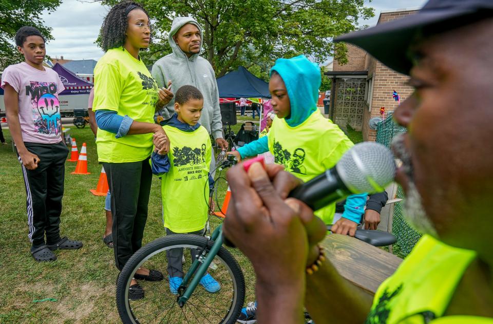 Andre Lee Ellis, right, lets those in line know that they have to have a red ticket in order to receive a bike during Ellis' birthday party and bike giveaway Saturday at 1313 W. Reservoir Ave. "When you give, you get. When you get, give," Ellis said. "If people would be nicer and kinder to one another then there is so much more that can happen."