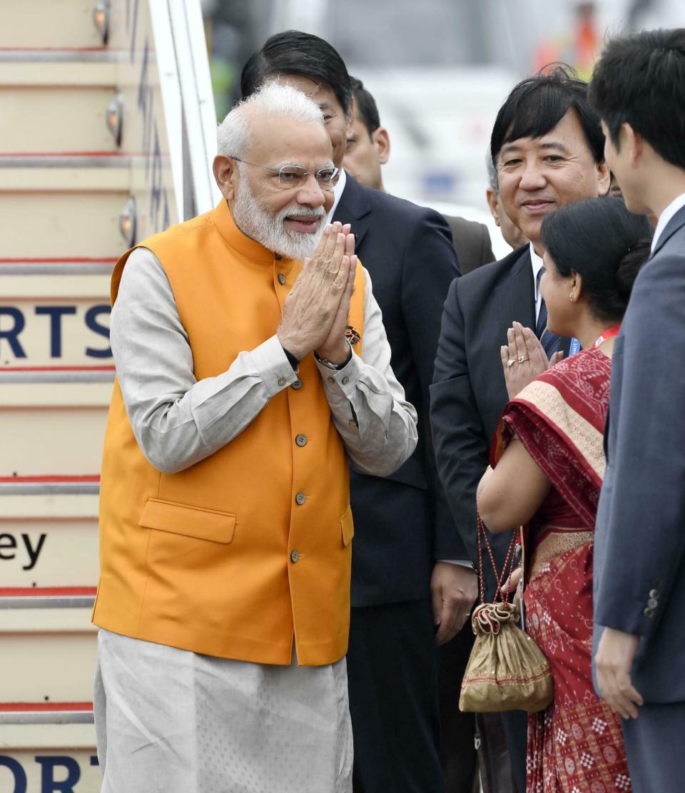 Indian Prime Minister Narendra Modi is greeted on his arrival at Kansai International Airport in Izumisano, Osaka prefecture, Thursday, June 27, 2019. Group of 20 leaders gather in Osaka on June 28 and 29 for their annual summit.(Nobuki Ito/Kyodo News via AP)