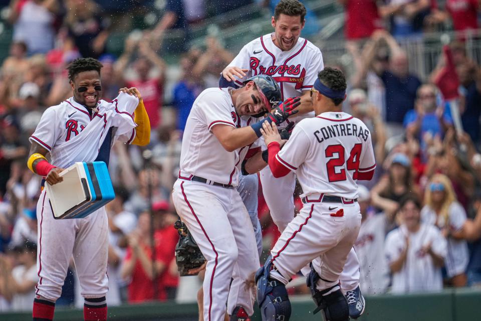 Braves players celebrate a walk-off win against the Nationals on Sunday.