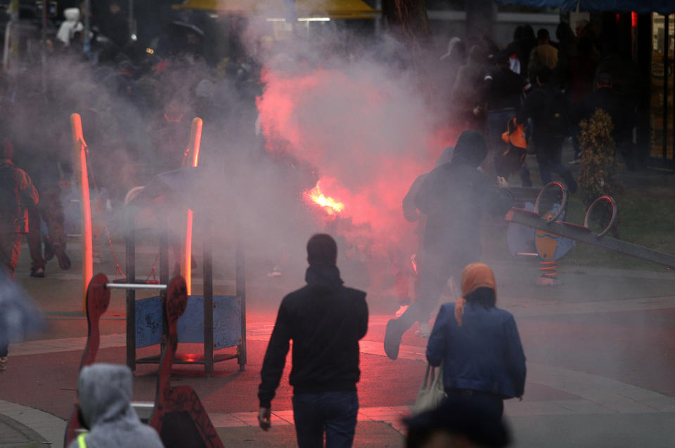 Anti-LGTBQ protesters throw a flare during the European LGBTQ pride march in Belgrade, Serbia, Saturday, Sept. 17, 2022. Serbian police have banned Saturday's parade, citing a risk of clashes with far-right activists. (AP Photo/Vladimir Milovanovic)