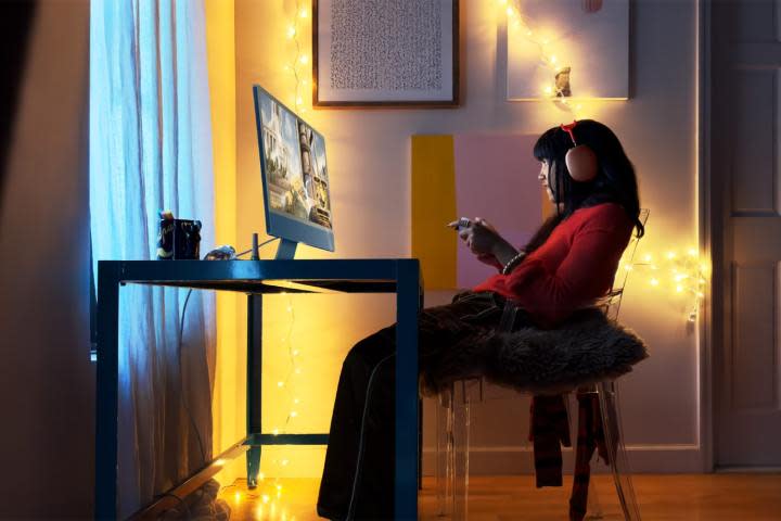 A person plays Firmament on an M3 iMac using a game controller.