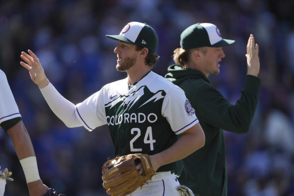 Colorado Rockies third baseman Ryan McMahon and teammates celebrate a win in a baseball game against the Chicago Cubs on Wednesday, Sept. 13, 2023, in Denver. (AP Photo/David Zalubowski)