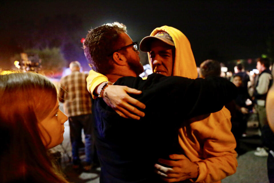 Holden Harrah, 21, (right), who witnessed the shooting at Borderline Bar &amp; Grill late Wednesday, hugs family and friends.<a href="https://www.huffingtonpost.com/entry/photos-show-scene-outside-thousand-oaks-bar-after-mass-shooting-leaves-12-dead_us_5be44733e4b0e8438894d380#5be44559e4b0e8438894ca2a" data-ylk="subsec:entry-image;itc:0" data-rapid-parsed="slk" data-rapid_p="1" data-v9y="1"></a> (Photo: Al Seib via Getty Images)