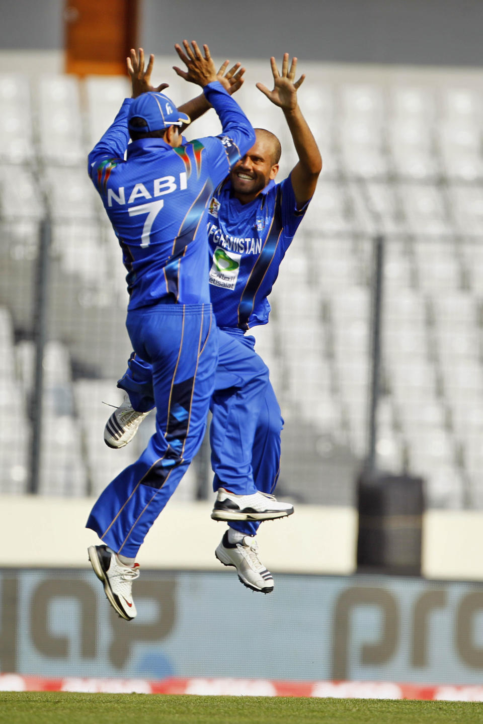 Afghanistan’s Mirwais Ashraf, right, celebrate with teammate Mohammad Nabi, after taking the wicket of Sri Lanka’s Mahela Jayawardene during the Asia Cup one-day international cricket tournament between them in Dhaka, Bangladesh, Monday, March 3, 2014. (AP Photo/A.M. Ahad)