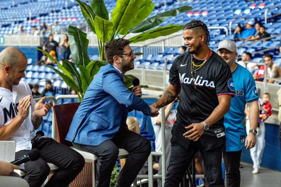 New Marlins General Manager Peter Bendix shakes hands with infielder Luis Arraez as he and Jake Burger introduce next season’s uniform during the Miami Marlins FanFest event at loanDepot park in Miami, Florida on Friday, January 26, 2024.