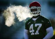 REFILE - ADDING NAME OF PLAYER Saskatchewan Roughriders' Mortty Ivy stands during practice in freezing temperatures in Regina, Saskatchewan, November 22, 2013. The Saskatchewan Roughriders will play against the Hamilton Tiger-Cats in the CFL's 101st Grey Cup in Regina. REUTERS/Mark Blinch (CANADA - Tags: SPORT FOOTBALL)