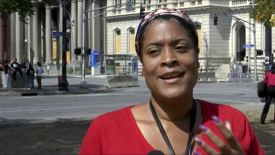 In this image made from video on Sept. 24, 2020, Chea Woolfolk speaks to a reporter on the streets of Louisville, Ky. Woolfolk, is one of many demanding justice for Breonna Taylor, the 26-year-old emergency medical technician shot and killed by police when they burst into her house in the middle of the night in a botched raid. (AP Photo/Mike Householder)