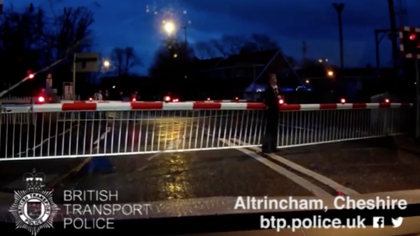 Boy runs across train tracks as level crossing barriers close and gets stuck