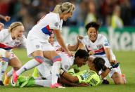 FILE PHOTO: Olympique Lyonnais goalkeeper Sarah Bouhaddi celebrates with her team mates after beating Paris St Germain 7-6 on penalties in the Women's Champions League final at the Cardiff City Stadium.