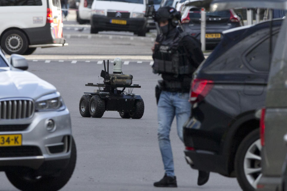 Dutch counter terrorism police use a robot as they prepare to enter a house after a shooting incident in Utrecht, Netherlands, Monday, March 18, 2019. A gunman killed three people and wounded nine others on a tram in the central Dutch city of Utrecht, sparking a manhunt that saw heavily armed officers with sniffer dogs zero in on an apartment building close to the shooting. (AP Photo/Peter Dejong)
