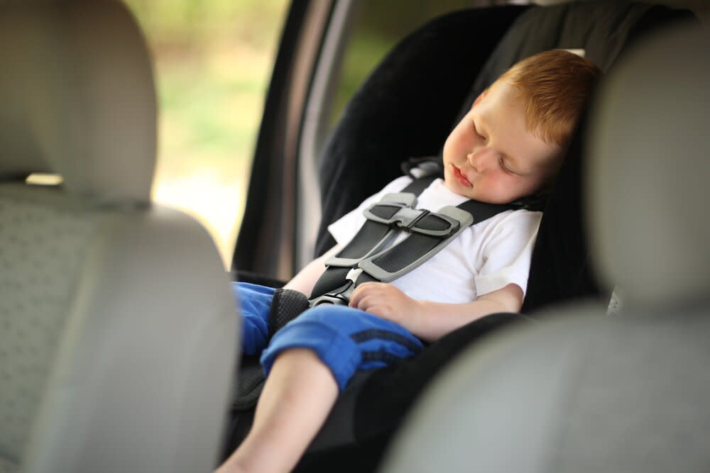 Boy sleeping in car seat