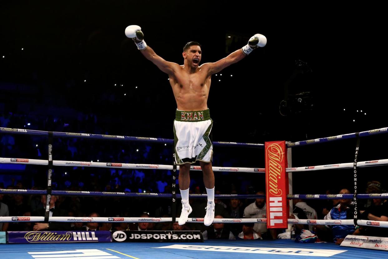 Happy days: Amir Khan celebrates after his 39-second demolition of Phil Lo Greco: Getty Images