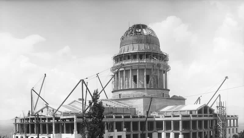 Image shows the construction progress of the Utah State Capitol. The dome is being built and the exterior is partially bricked, June 20, 1914.