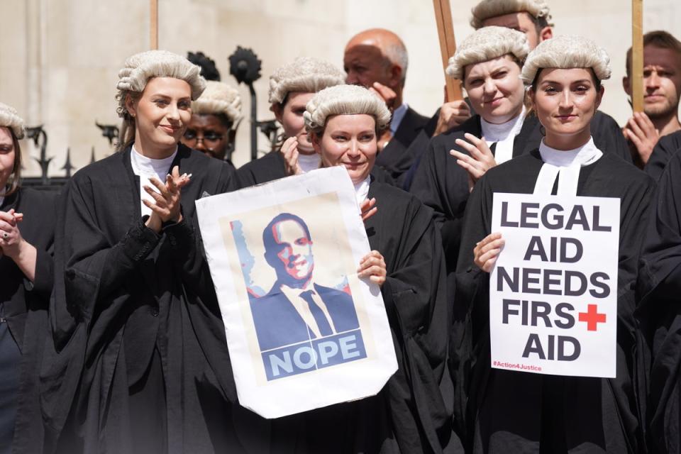Criminal defence barristers gather outside the Royal Courts of Justice during an earlier strike (PA) (PA Wire)