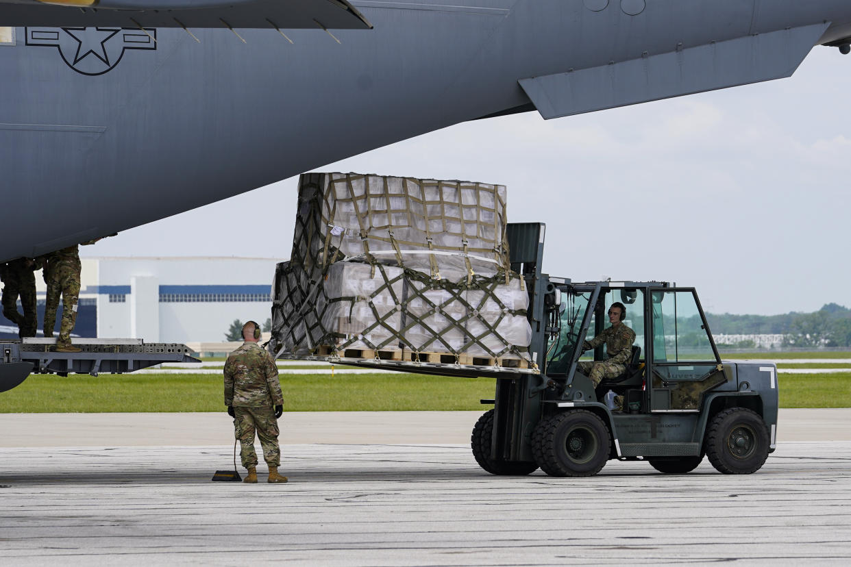 Crew members of an Air Force C-17 unload a plane load of baby formula at the Indianapolis International Airport in Indianapolis, Sunday, May 22, 2022. The 132 pallets of Nestlé Health Science Alfamino Infant and Alfamino Junior formula arrived from Ramstein Air Base in Germany. (AP Photo/Michael Conroy)