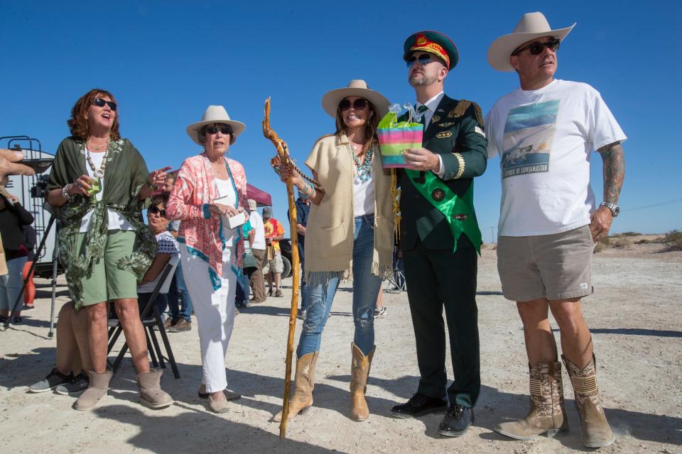 Self-proclaimed Sultan Randy Williams, the owner of an 11-acre plot of undeveloped land near Ocotillo Wells in Imperial County, Calif., greets Michelle MacLaggan,left, and Paul Bortoli at his micronation known as &quot;The Republic of Slowjamastan&quot; on Sunday, Feb. 6, 2022.