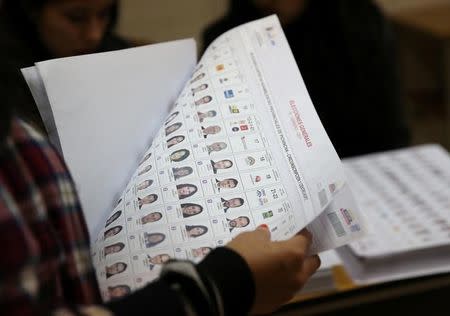 A woman checks her vote during Ecuador's presidential election at a polling station in Quito, Ecuador, February 19, 2017. REUTERS/Mariana Bazo