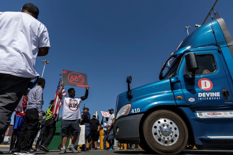 An independent truck driver attends a gathering to delay the entry of trucks at a container terminal at the Port of Oakland, during a protest against the new law AB5 in Oakland, California