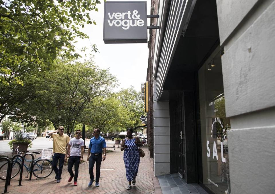 Pedestrians walk past Vert & Vogue in downtown Durham on Thursday July 5, 2018.