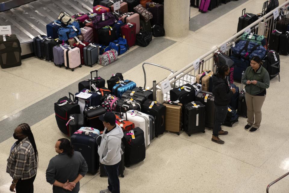 FILE - Hundreds of Southwest Airlines checked bags are piled together at baggage claim at Midway International Airport, Dec. 28, 2022, in Chicago. Senators who want to impose tougher penalties when U.S. airlines strand or delay passengers say they finally might be able to turn their ideas into law because of outrage over debacles like the one at Southwest Airlines in December 2022. (AP Photo/Erin Hooley, File)