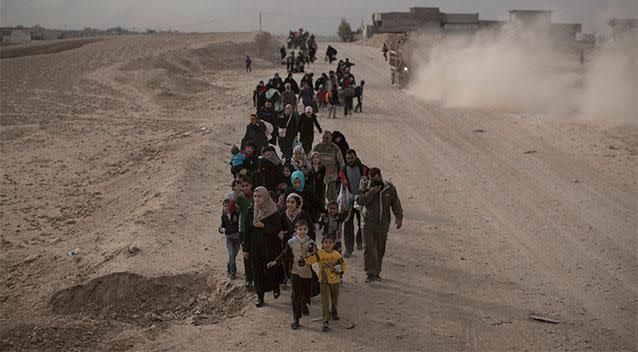 Internally displaced people flee fighting between Iraqi forces and Islamic State militants on a road in eastern Mosul, Iraq. Photo: AP
