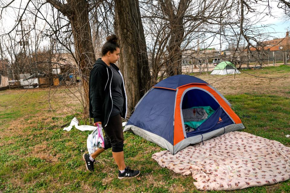 Homeless client Britnie K. returns to her tent on March 6 after receiving supplies during a Mental Health Association of Oklahoma homeless outreach stop in Oklahoma City.