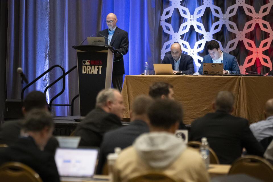 Jeff Pfeifer, top left, leads the Rule 5 Draft during the Major League Baseball winter meetings Wednesday, Dec. 6, 2023, in Nashville, Tenn. (AP Photo/George Walker IV)