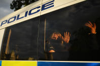 LONDON, ENGLAND - SEPTEMBER 01: Protestor waves from the back of a police van as Extinction Rebellion demonstrate in Westminster on September 1, 2020 in London, England. The environmental activist group organised several events across the UK timed for the return of government officials from the summer holiday. (Photo by Peter Summers/Getty Images)