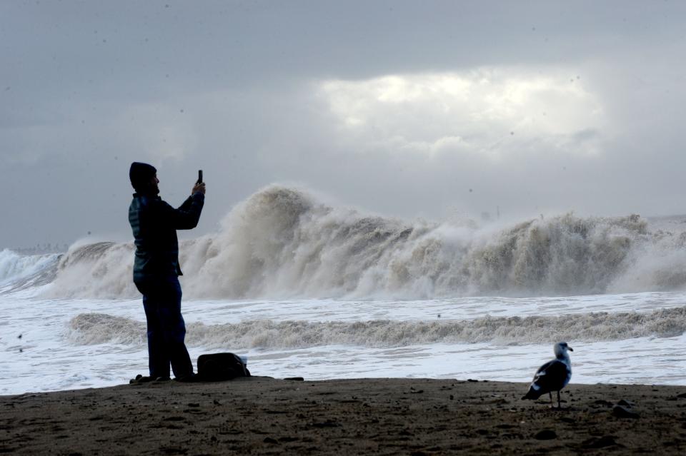 Ventura resident Tony Ochoa documents big waves hitting the Ventura Pier Thursday morning after a large storm swept in overnight.