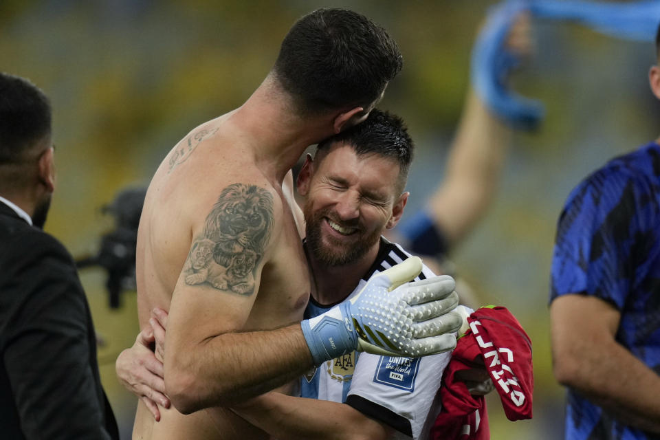 Argentina's Lionel Messi embraces goalkeeper Emiliano Martinez as they celebrate their team's 1-0 victory over Brazil at the end of a qualifying soccer match for the FIFA World Cup 2026 at Maracana stadium in Rio de Janeiro, Brazil, Tuesday, Nov. 21, 2023. (AP Photo/Silvia Izquierdo)