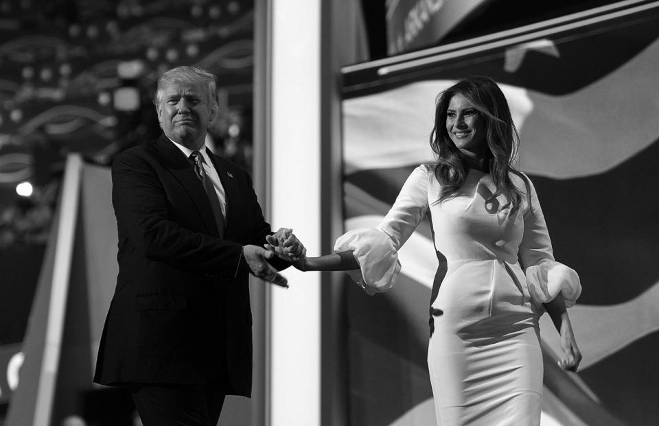 <p>Donald Trump walks off with his wife, Melania, after she spoke at the Republican National Convention on Monday. (Photo: Khue Bui for Yahoo News)</p>