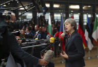 British Prime Minister Theresa May speaks with the media as she arrives for an EU summit in Brussels, Wednesday, Oct. 17, 2018. European Union leaders are converging on Brussels for what had been billed as a "moment of truth" Brexit summit but which now holds little promise for a breakthrough. (AP Photo/Francisco Seco)