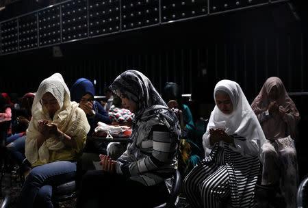 Staff at Boshe VVIP Club listen to a sermon by Mifta'im An'am Maulana Habiburrohman, or Gus Miftah, a 37-year-old Muslim preacher who aims to create a safe space to worship for those who work in the entertainment industry, in Kuta, Bali, Indonesia November 27, 2018. REUTERS/Nyimas Laula/Files