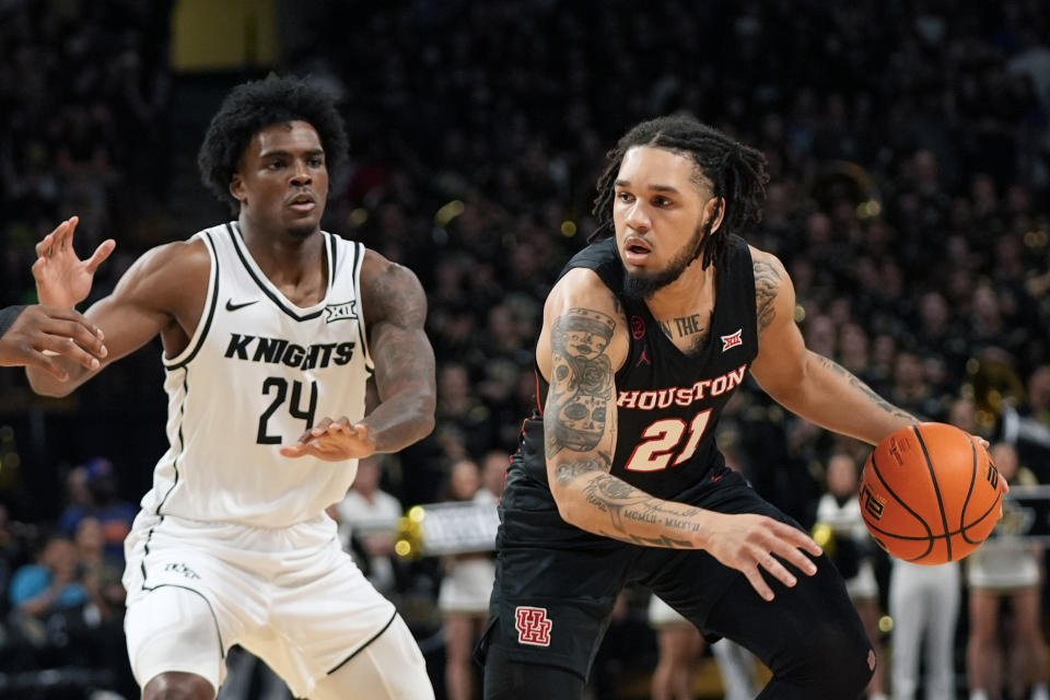 Houston guard Emanuel Sharp (21) looks for a way around Central Florida guard Jaylin Sellers (24) during the first half of an NCAA college basketball game, Wednesday, March 6, 2024, in Orlando, Fla. (AP Photo/John Raoux)