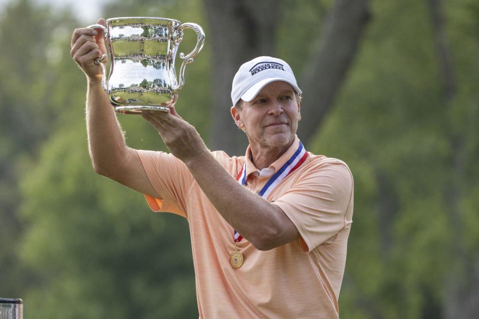 Steve Stricker hoists the championship trophy after winning the U.S. Senior Open Sunday at Notre Dame’s Warren Golf Course.